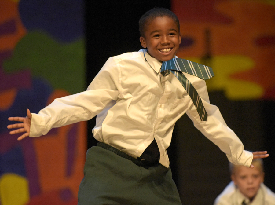 kid in tie smiling and dancing