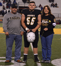 player standing with parents