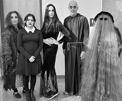 black and white photo of people dressed as adams family