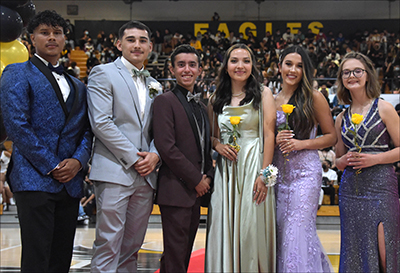 students standing in formal wear looking at camera