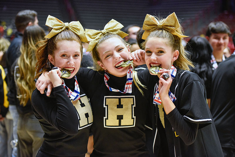 Three cheerleaders with medals