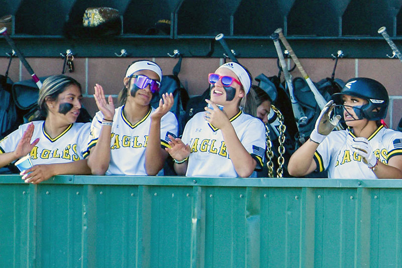 smiling girls in the dugout