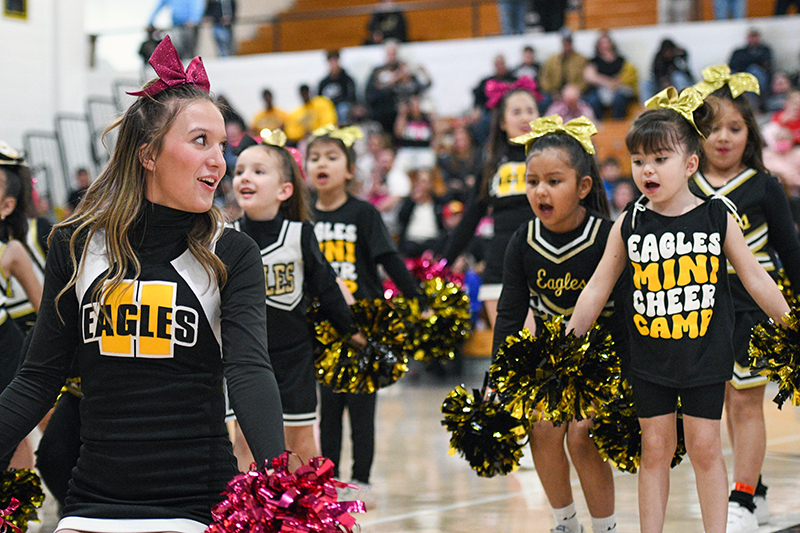 cheerleader with young girls cheering