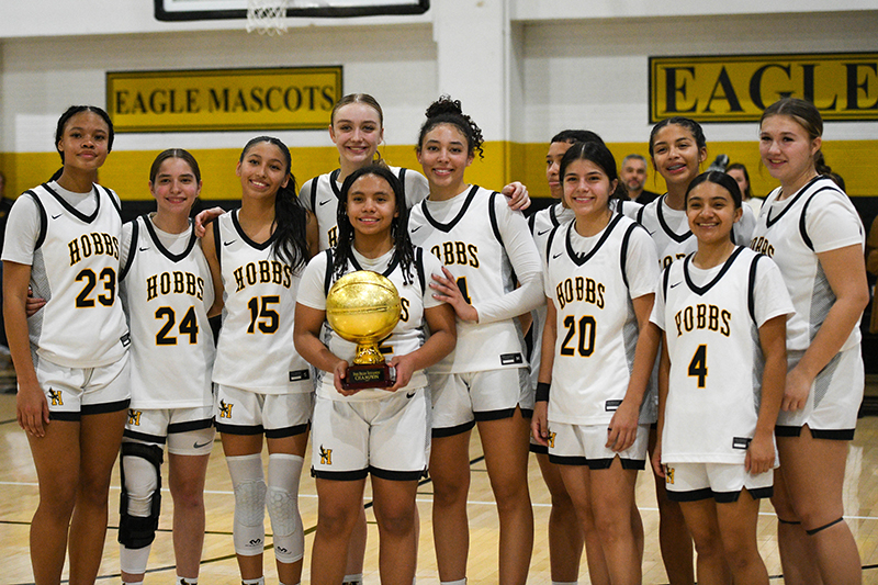 girls standing with trophy
