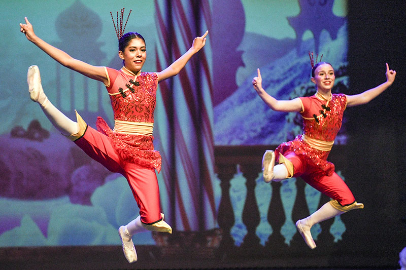 two dancers leaping