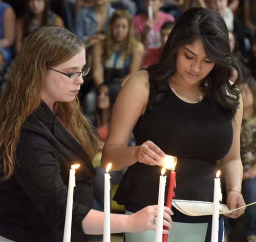 students holding candles