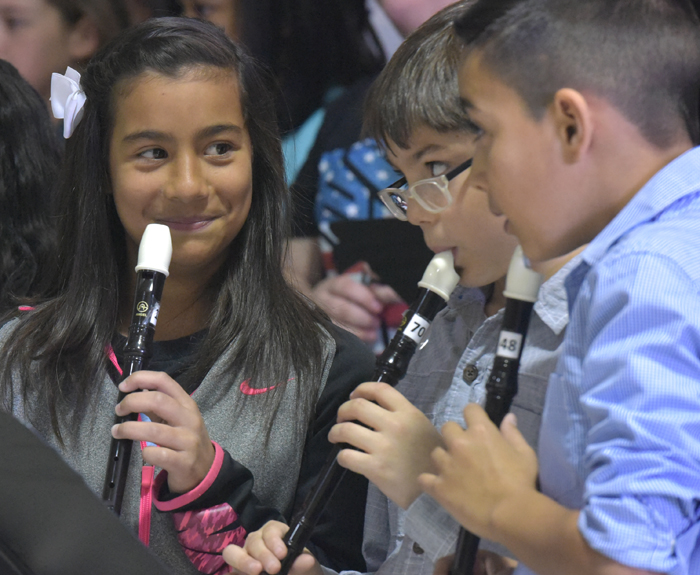 three students with recorders
